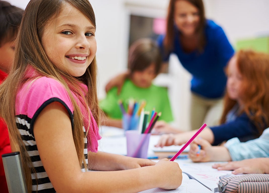 girl-at-table-with-students girl-at-table-with-students