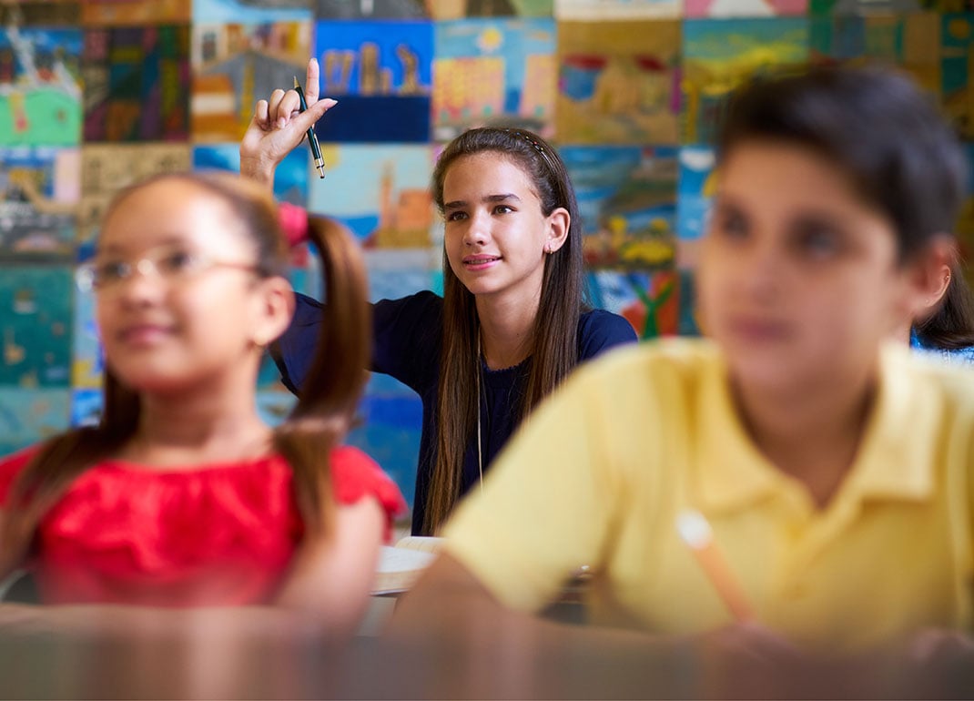 girl-raising-hand-in-class girl-raising-hand-in-class