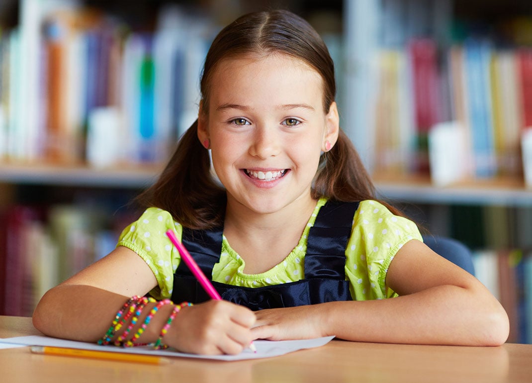 girl-writing-in-library